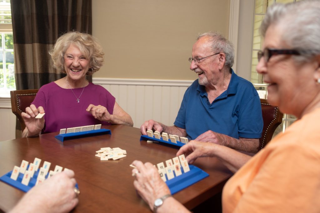 A couple plays a game in the game room at The Manor at York Town